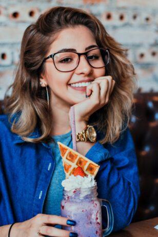 woman in eyeglasses with black frames posing for photo