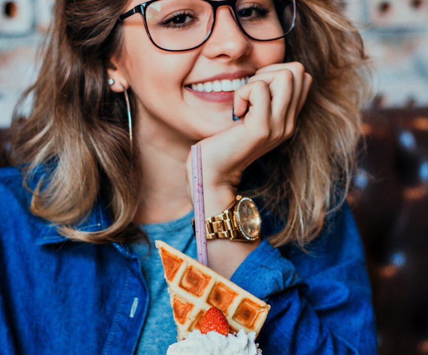 woman in eyeglasses with black frames posing for photo