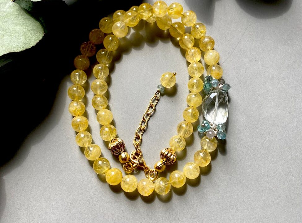 close up of a necklace with yellow beads