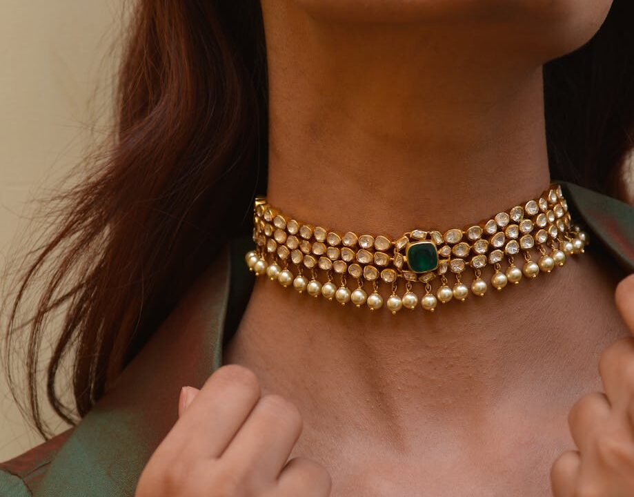 golden necklace and earring on woman