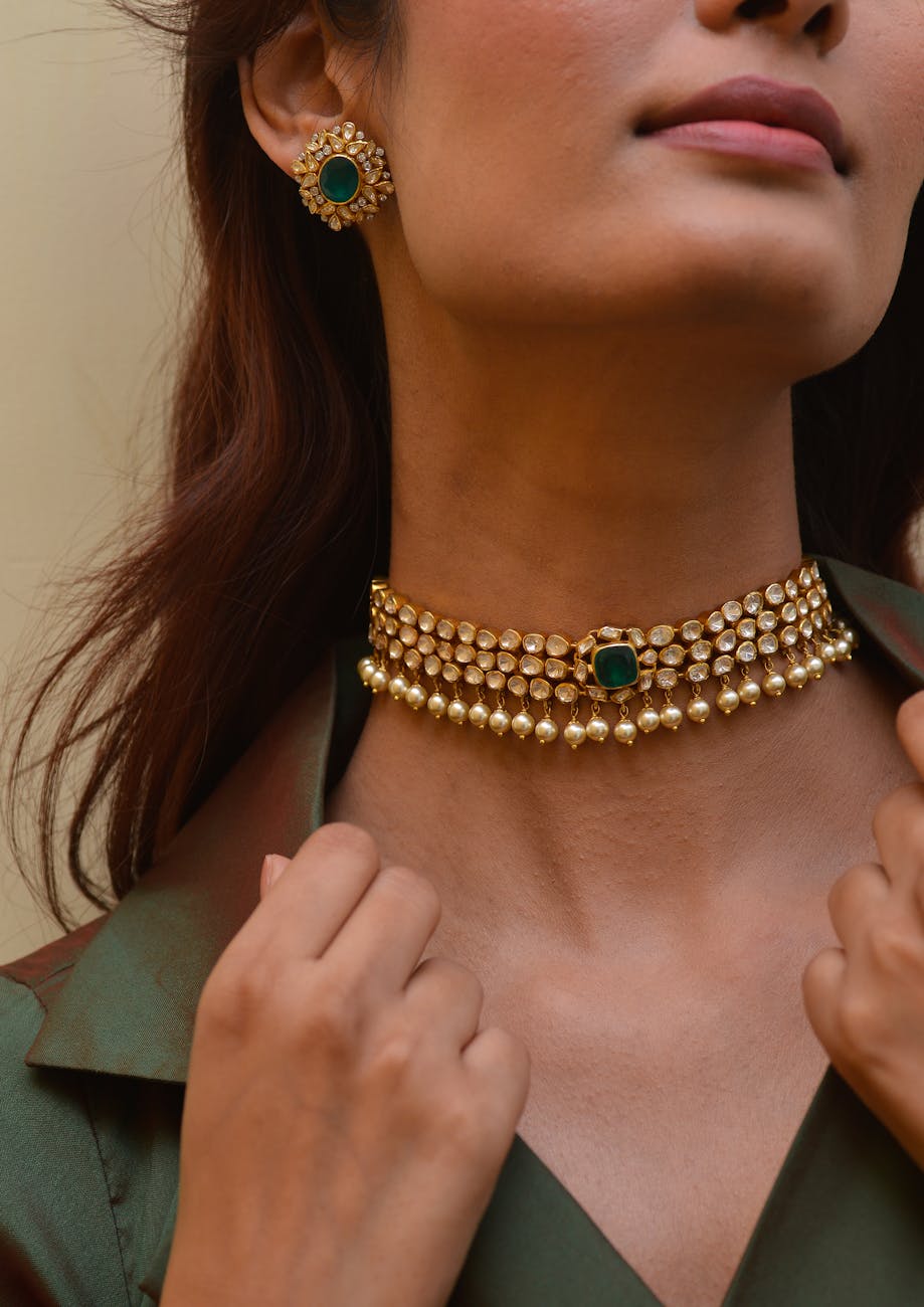 golden necklace and earring on woman