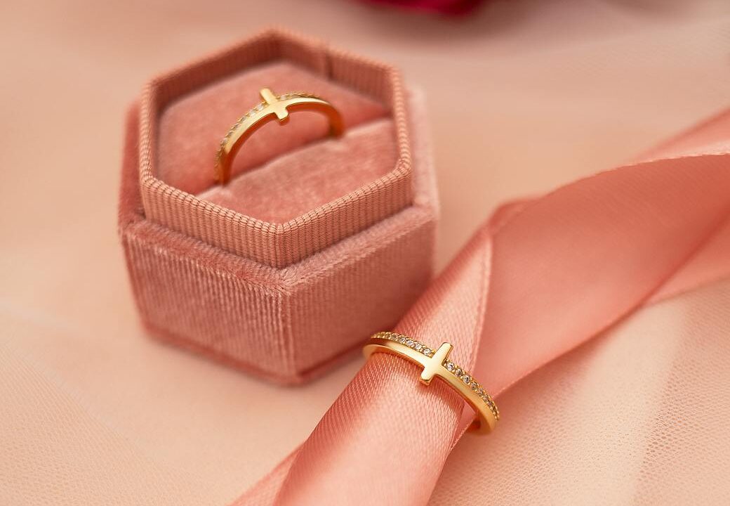 elegant gold ring in velvet box with roses