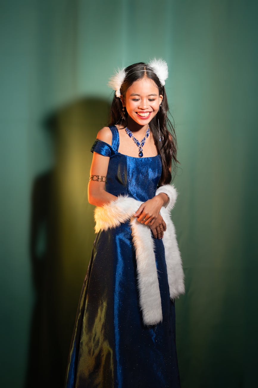 young woman in elegant blue dress smiling