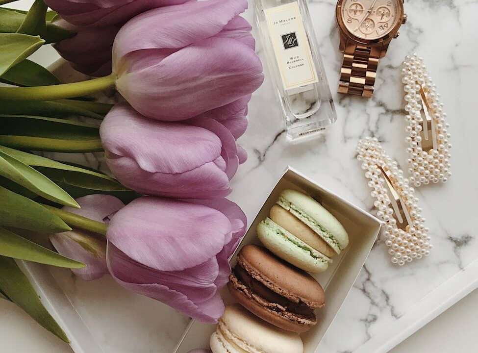 flat lay shot of macaroons and flowers