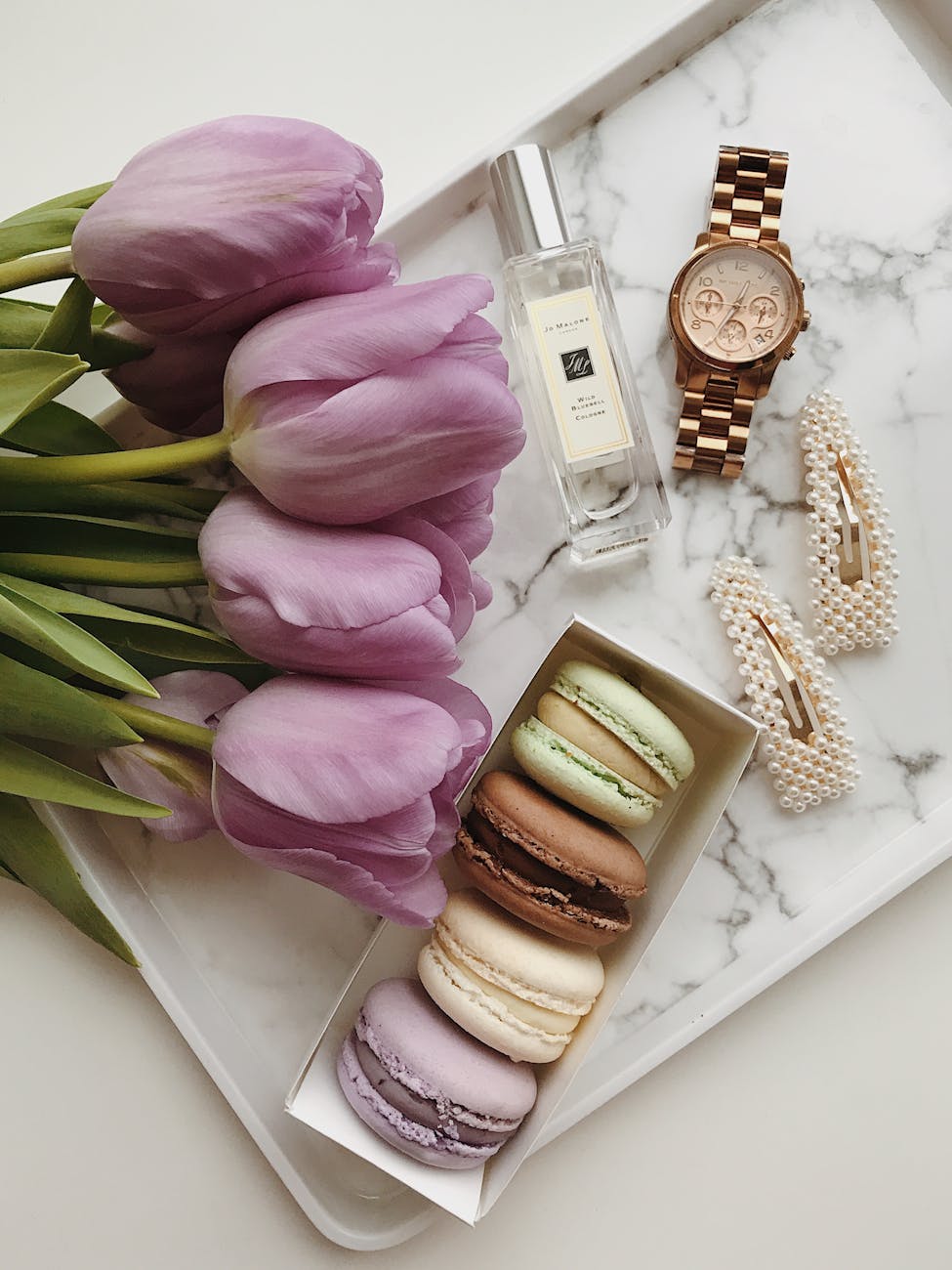 flat lay shot of macaroons and flowers