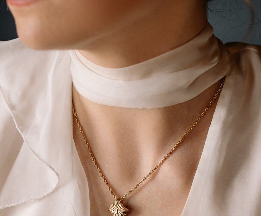 woman wearing gold necklace