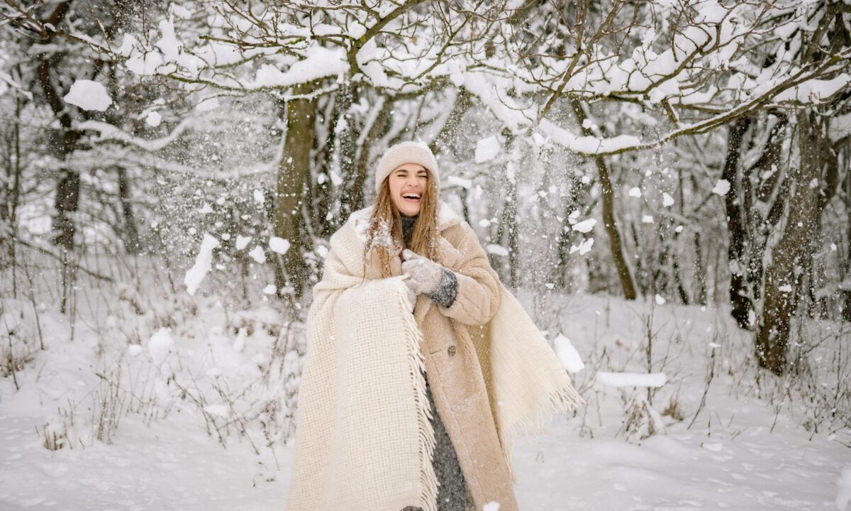 a woman standing on the snow covered ground