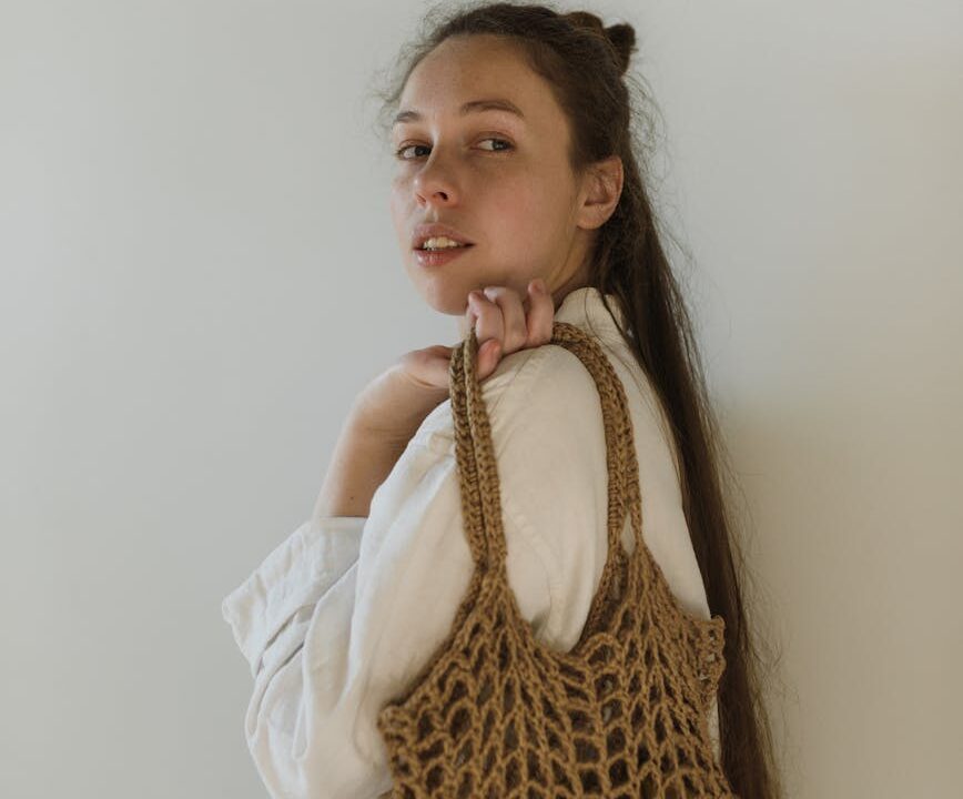 calm young woman with cotton sack in hand