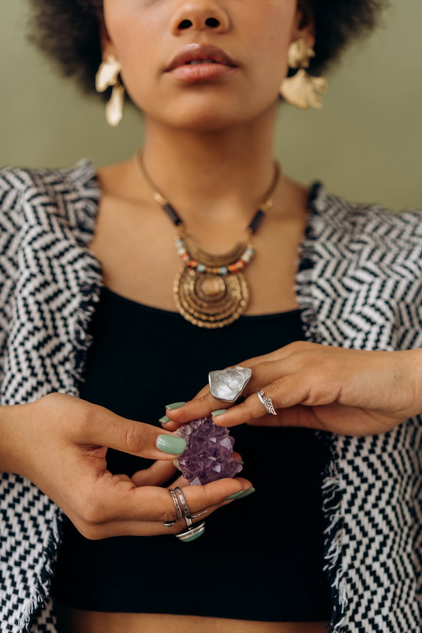 a woman holding an amethyst crystal