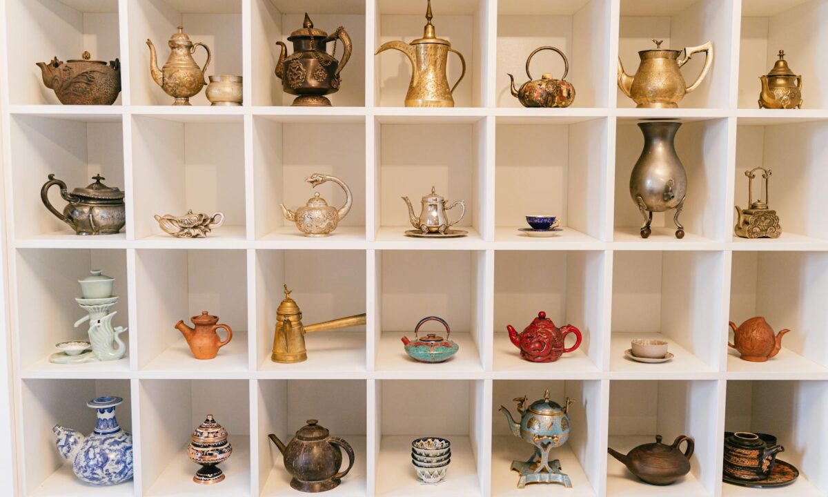 a variety of teapots in a shelf