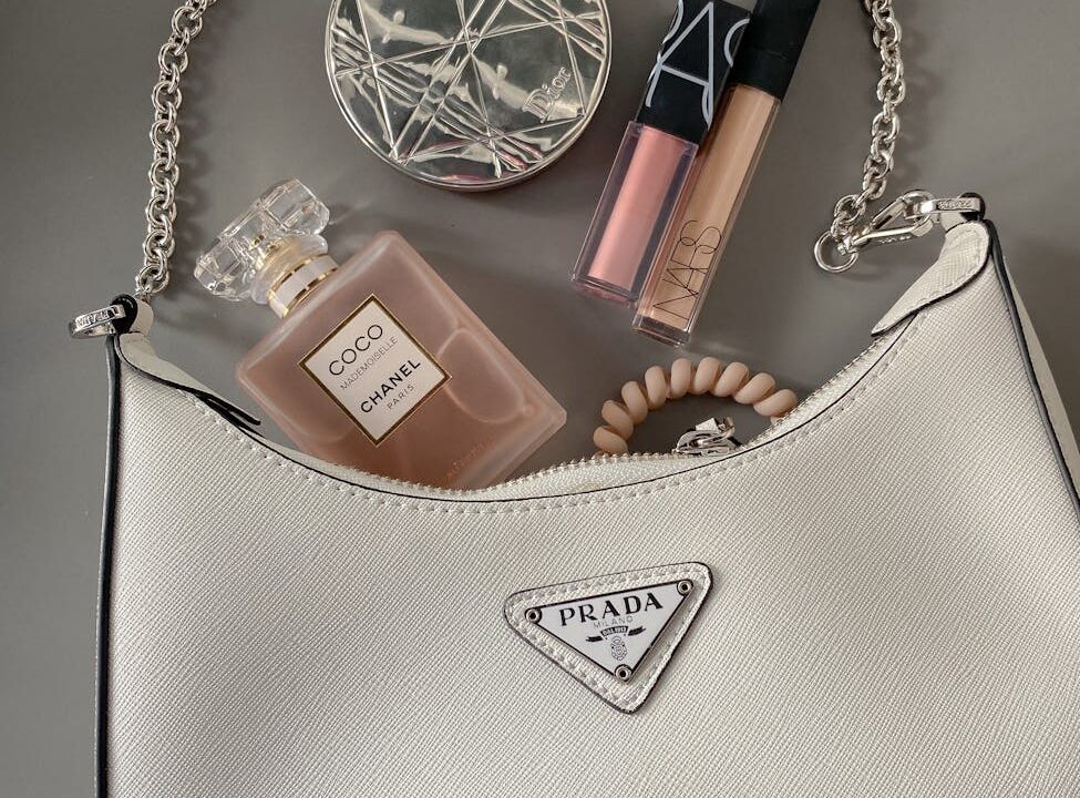 flatlay shot of a bag with makeup and perfume