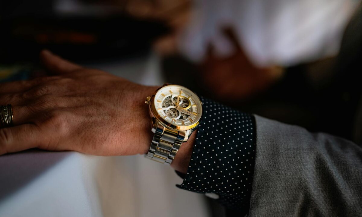 close up photo of a silver and gold wristwatch